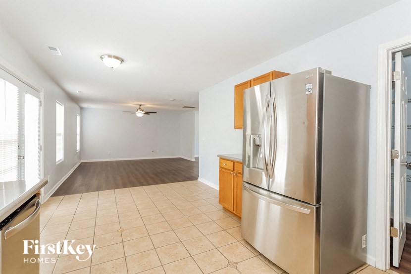 a kitchen with a stainless steel refrigerator in the middle of it
