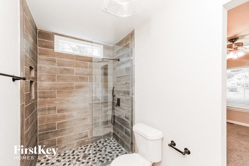 a bathroom with a shower and a toilet