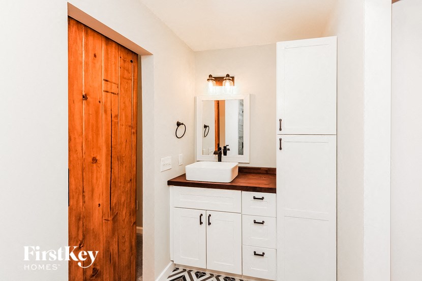 a small bathroom with a sink and a mirror