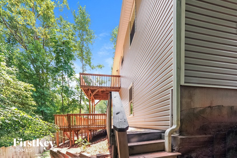 a house with a wooden deck on the side of it
