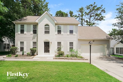 a white house with a lawn in front of it