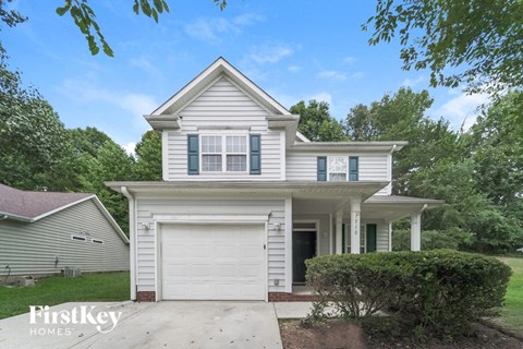 a white house with a white garage door