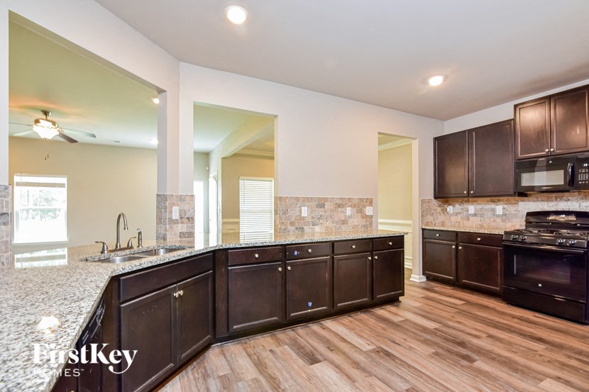 the kitchen is open to the dining room and living room
