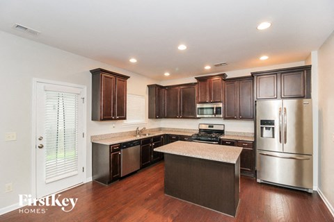 A kitchen with wooden cabinets and stainless steel appliances.