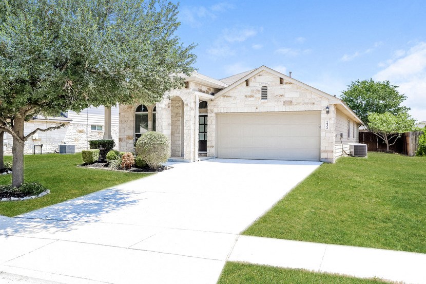 a white house with a driveway and a garage door