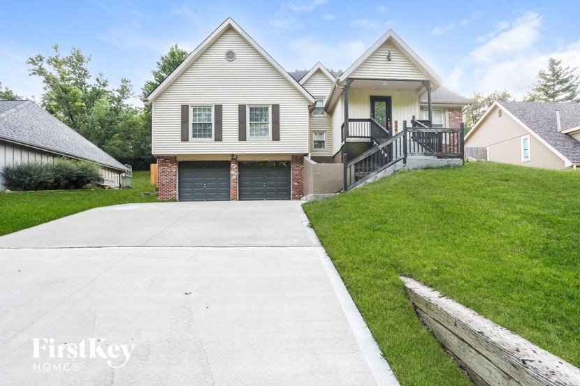 a white house with a driveway and a garage door