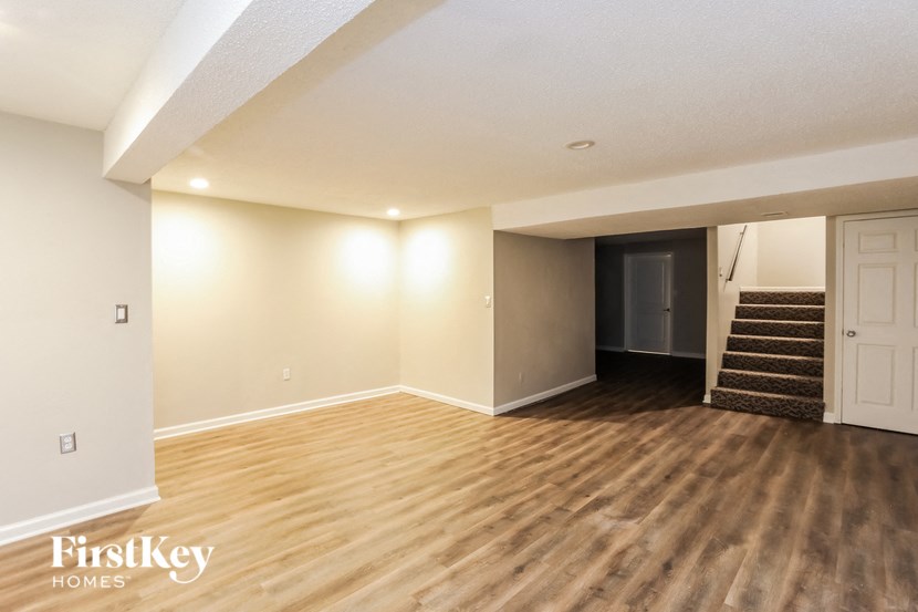 the living room and entryway of an empty house
