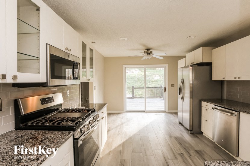 a kitchen with stainless steel appliances and hardwood floors