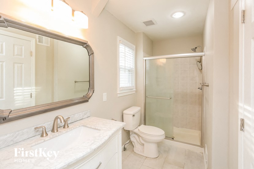 a bathroom with a sink toilet and a shower
