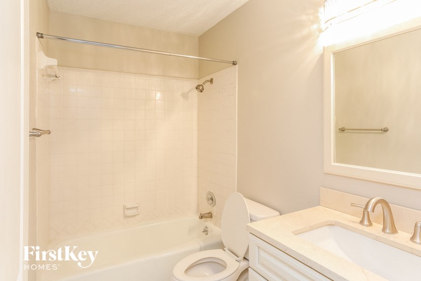 a bathroom with a toilet and a sink and a bath tub