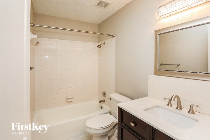 a bathroom with a sink toilet and a bath tub