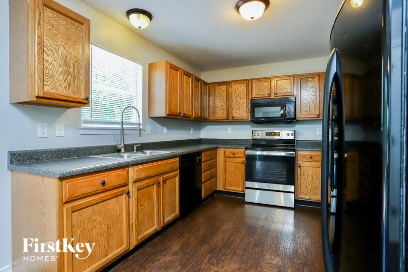 a kitchen with black appliances and wooden cabinets