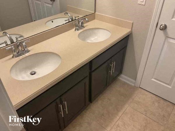 a bathroom with two sinks and a mirror