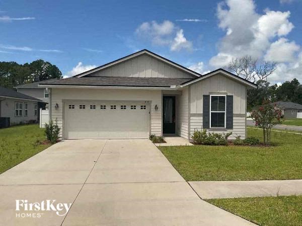 a white house with a driveway in front of it