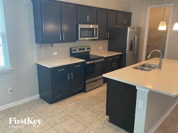 a kitchen with black cabinets and a sink