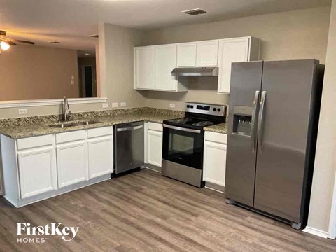 a kitchen with stainless steel appliances and white cabinets