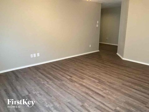a living room with hardwood flooring and white walls