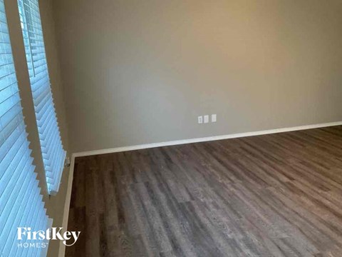 an empty room with wood floors and a window
