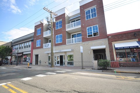 an apartment building on the corner of a city street