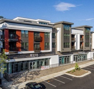 a view of a building with a parking lot