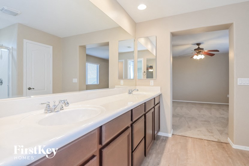 A bathroom with a double sink vanity and a large mirror.