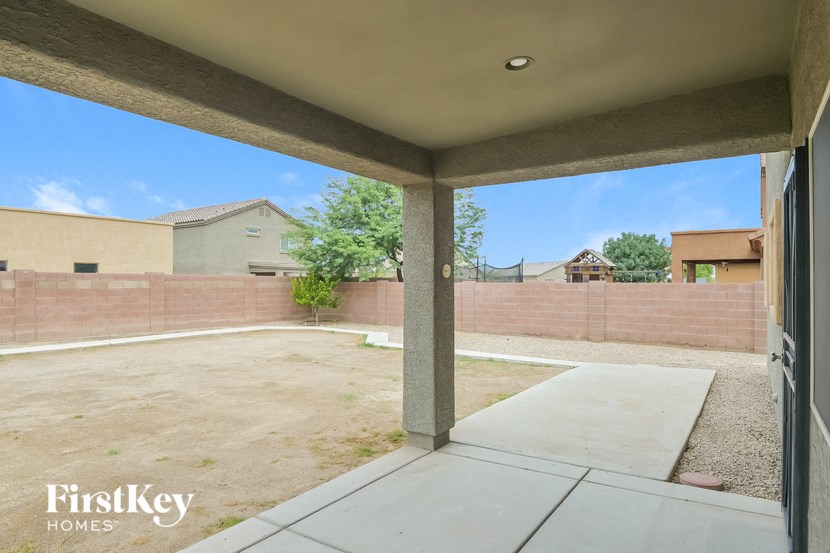 A patio area with a concrete floor and a concrete pillar.