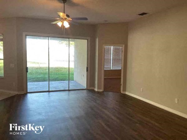 A room with a sliding glass door leading to a backyard.