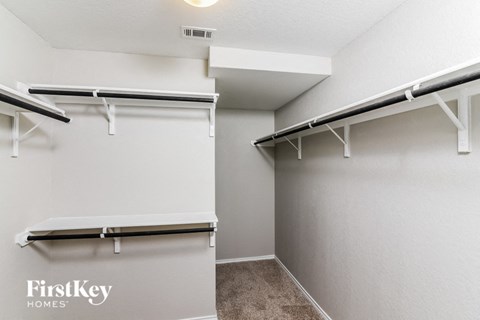 A white wall with a FirstKey Homes sign on it.