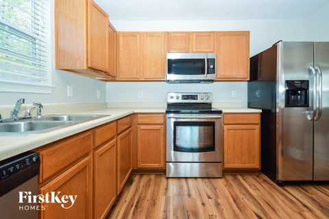 A kitchen with wooden cabinets and stainless steel appliances.
