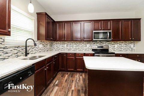 A kitchen with wooden cabinets and a white countertop.