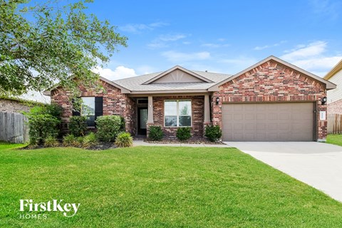 A house with a garage and a driveway is for sale.