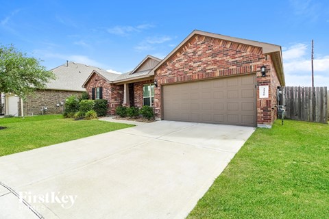 A brick house with a garage door and a driveway.