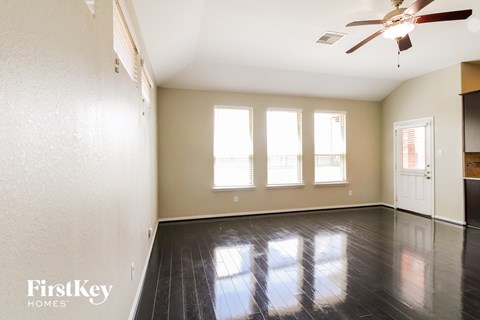 A room with a fan and a door.