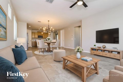 A living room with a wooden coffee table and a blue couch.