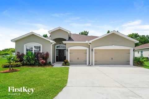 A house with a garage and a driveway is for sale.