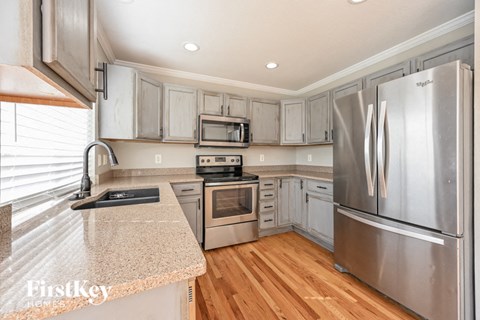a kitchen with stainless steel appliances and granite counter tops