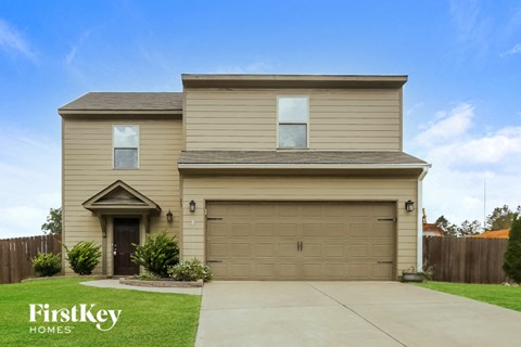 a house with a garage door and a driveway