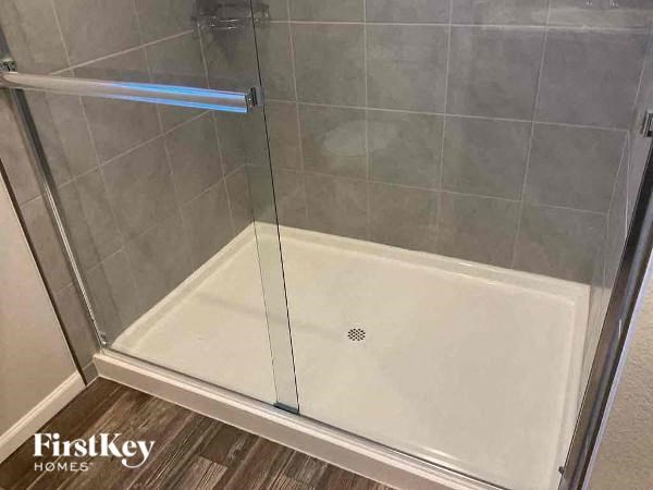 a shower with a glass door in a bathroom