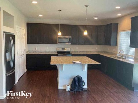 a kitchen with black cabinets and a counter top