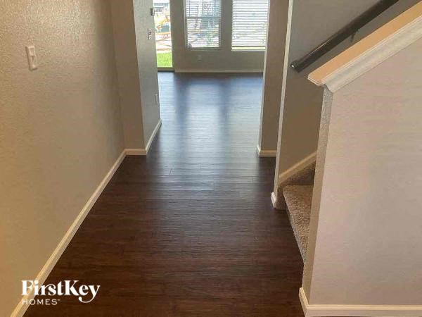 a hallway with a hard wood floor and a doorway