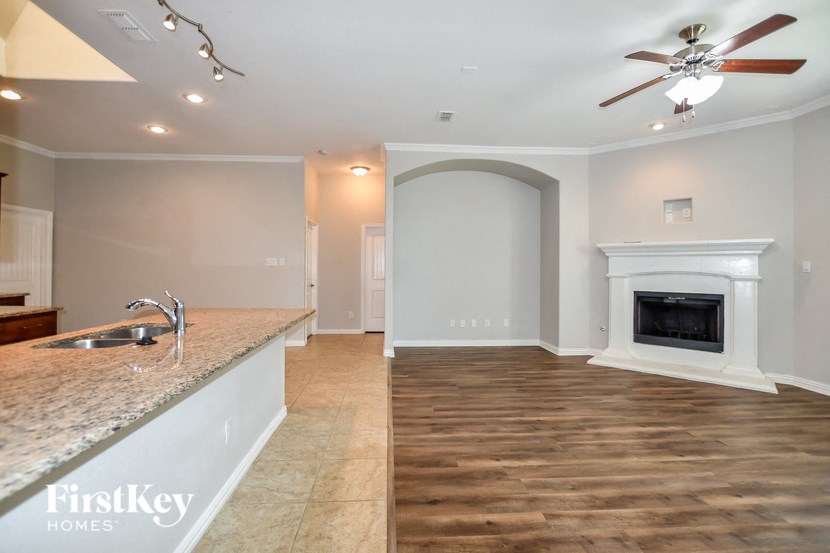 the kitchen and living room with fireplace