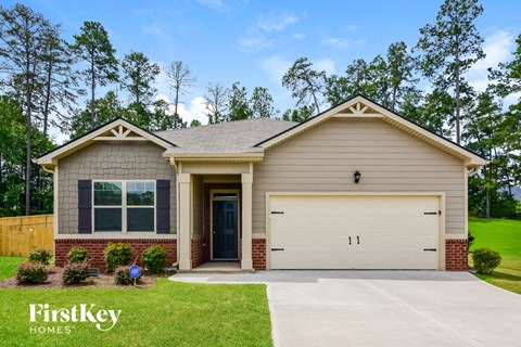 a beige house with a white garage door
