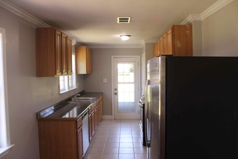 a kitchen with a refrigerator and a sink