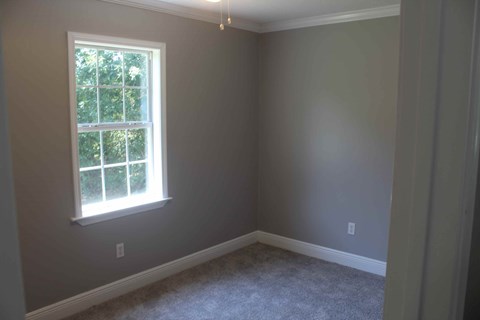 a empty room with a window and carpet