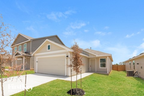 a house with a lawn and a driveway
