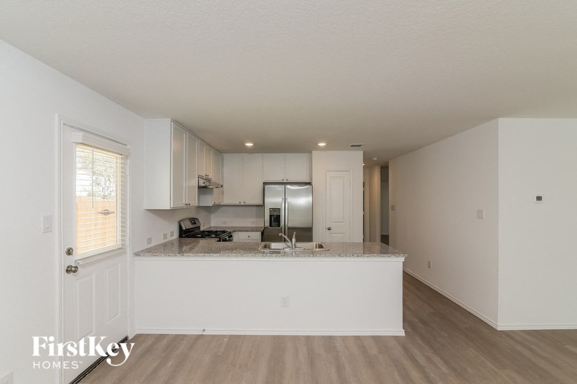 a kitchen with white cabinets and a counter top
