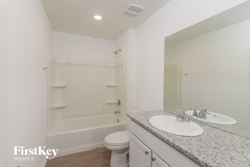 a bathroom with a sink and a shower and a toilet