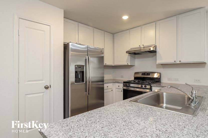a kitchen with stainless steel appliances and white cabinets