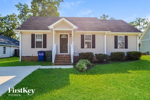 A house with a brown door and a small porch.