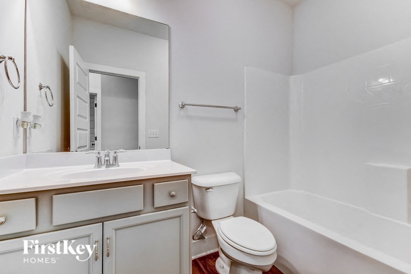 a bathroom with a sink toilet and a bath tub